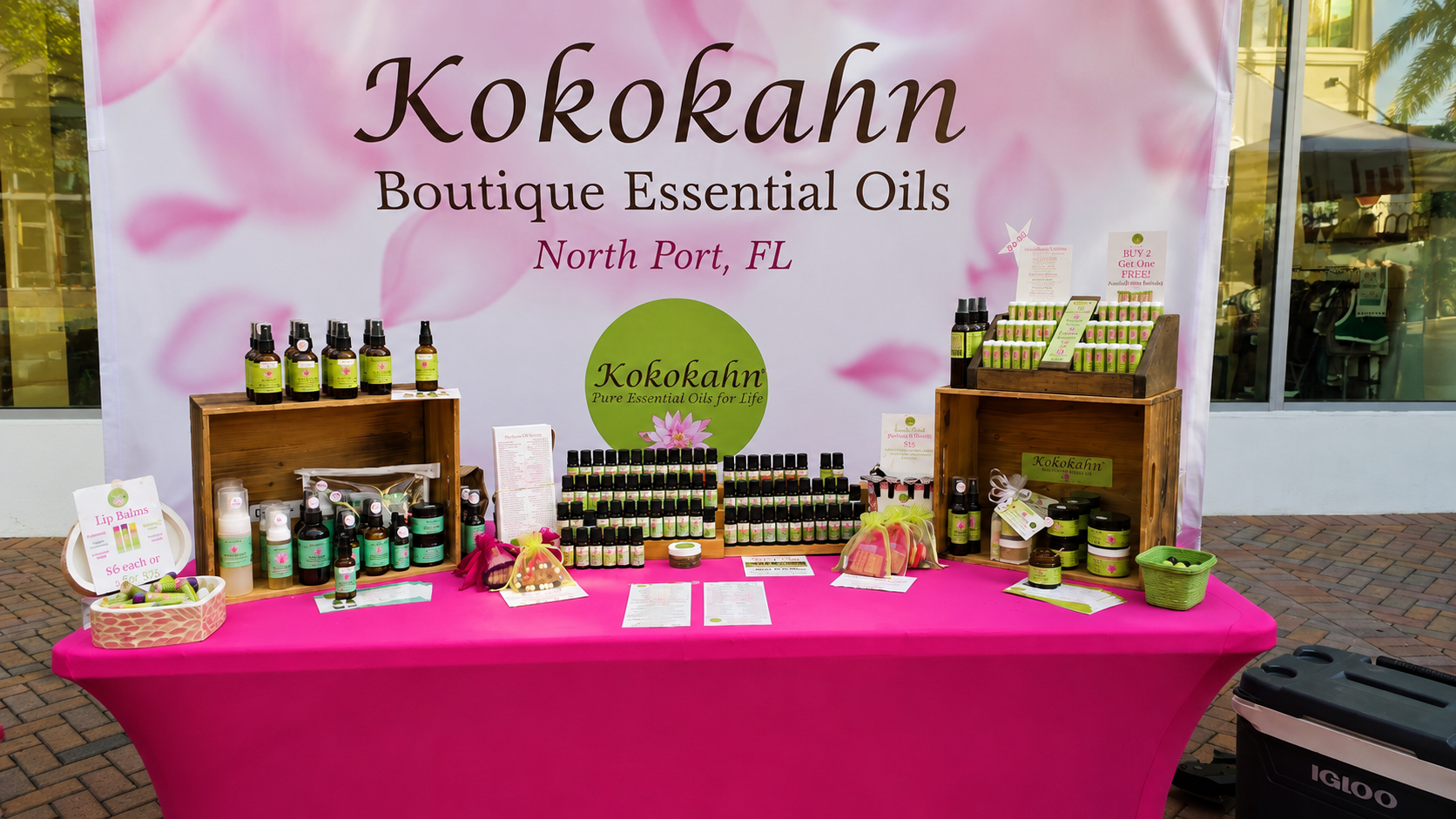 Kokokahn Essential Oils booth at a local farmers market featuring essential oils, roll-ons, sprays, balms, and natural wellness products.